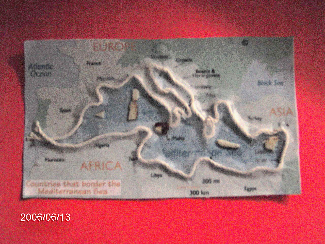 Photograph of a relief map of the shoreline and major islands of the Mediterranean Sea, made with string on a flat surface